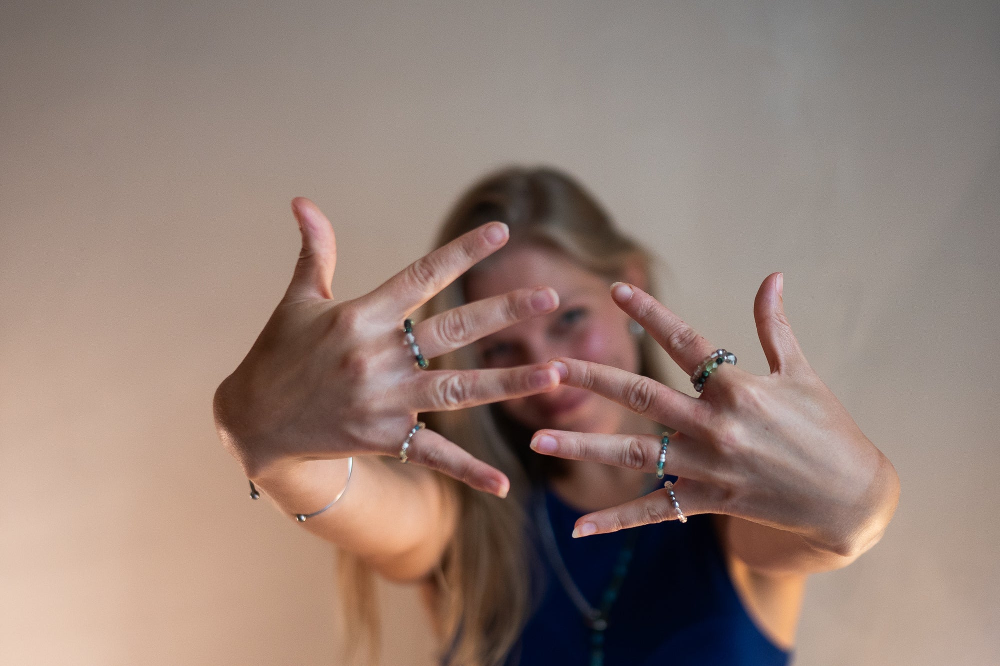 Joyfull and happy photo of SOIRA founder and female business owner Sarah Hanisch wearing SOIRA jewlry. SOIRA necklace, rings, bracelets and belt.