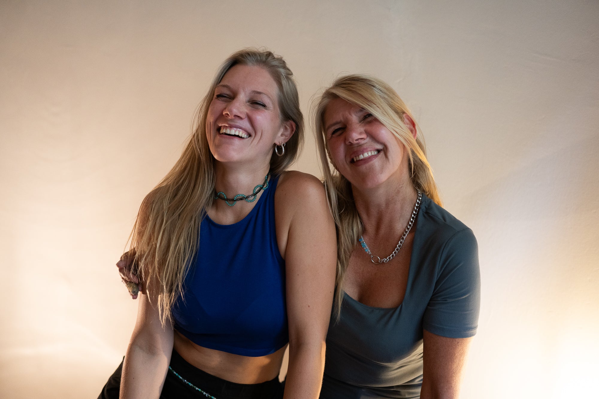 Joyfull and happy photo of SOIRA founders and female business owner Sarah Hanisch and Yvonne Hartung wearing SOIRA jewlry. SOIRA necklace, rings, bracelets and belt.
