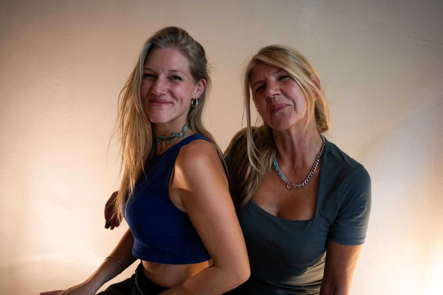 Joyfull and happy photo of SOIRA founders and female business owner Sarah Hanisch and Yvonne Hartung wearing SOIRA jewlry. SOIRA necklace, rings, bracelets and belt.